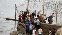 Des personnes sont rassemblées à côté d'une clôture près de Fnideq, à la frontière entre le Maroc et l'Espagne, le 31 juillet 2026