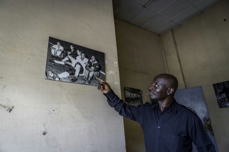 Hassim Tall Boukambou, réalisateur et documentariste, montre une photo d'archives accrochée au mur de l'ancien siège de Télé Congo à Brazzaville, le 3 mars 2026 au Congo
