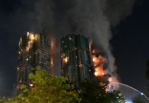 Des pompiers luttent contre un incendie qui s'est déclaré dans le complexe résidentiel Wang Fuk Court, dans le quartier de Tai Po, le 26 novembre 2025 à Hong Kong