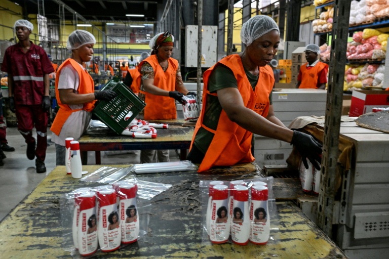 Des employées emballent des produits cosmétiques dans l'usine Kaera, située dans la zone industrielle de Yopougon, en périphérie d'Abidjan, le 7 juillet 2026 en Côte d'Ivoire