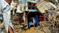 Un homme retire la boue de l'intérieur d'une maison suite aux crues subites dans la province montagneuse de Khyber Pakhtunkhwa au Pakistan le 16 août 2025