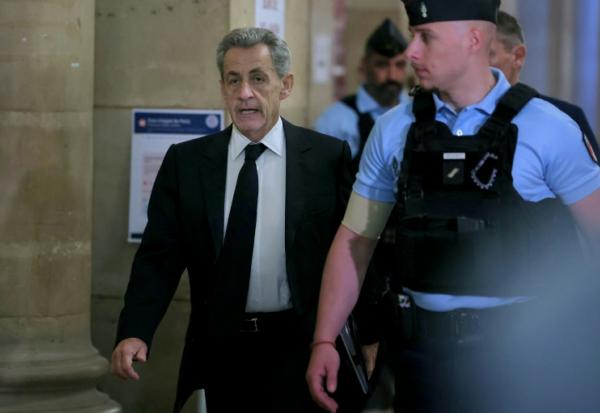 L'ancien président Nicolas Sarkozy (g) arrive au palais de justice de Paris, le 8 avril 2026, pour son procès en appel dans l'affaire du financement libyen de sa campagne électorale de 2007