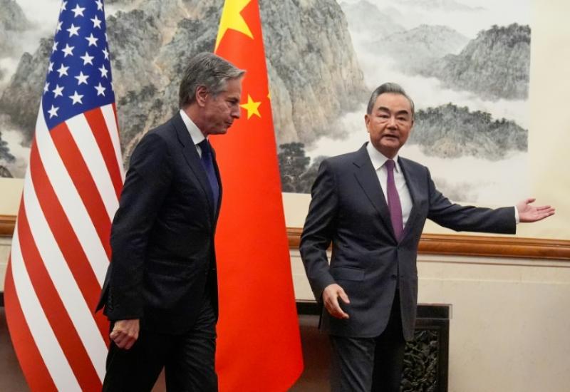 Le secrétaire d'Etat américain Antony Blinken (G) suit le ministre chinois des Affaires étrangères Wang Yi (D) à  Pékin le 26 avril 2024