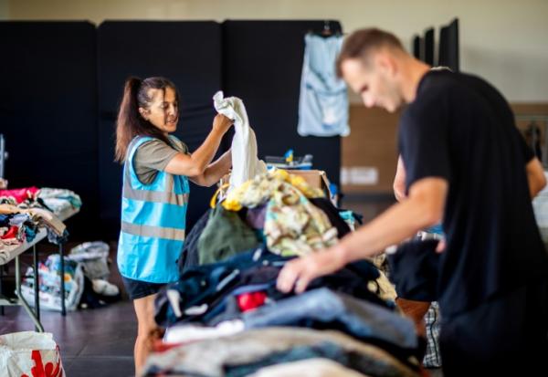 Des bénévoles rassemblent des vêtements collectés pour les touristes et personnes évacués à Canet-en-Roussillon (sud) le 3 juillet 2026.