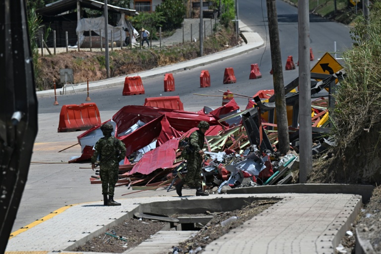 Des soldats se tiennent près des restes d'un péage en construction détruit par une explosion à Santander de Quilichao, en Colombie, le 8 août 2026