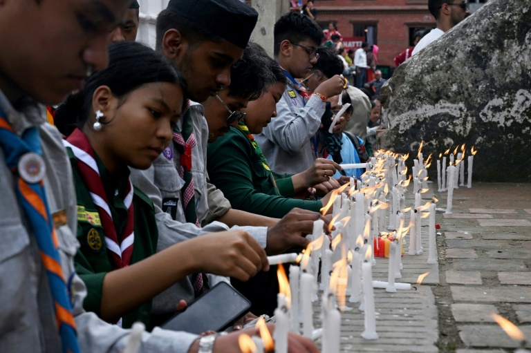 Des scouts népalais allument des cierges à Katmandou en mémoire des victimes de la gigantesque crue dans l'Himalaya qui a fait plus de 600 morts et quelque 3.000 disparus, le 29 août 2026 