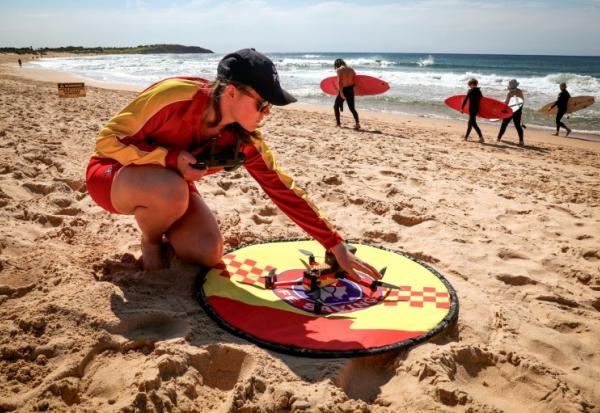 La secouriste Eliza Heys vérifie un drone après son atterrissage sur une plage à Sydney, le 1er octobre 2025