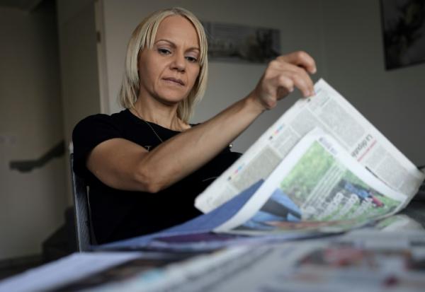 La Marocaine Yasmina Tellal, consulte des coupures de presse, dans le sud-ouest de la France, le 15 août 2025