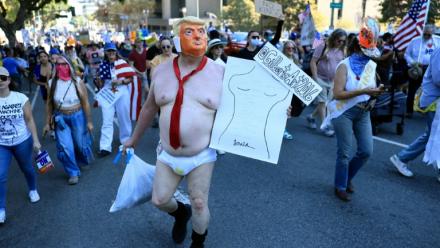 Un manifestant vêtu d'un costume se moquant du président américain Donald Trump participe à la journée nationale de manifestations "No Kings" à Los Angeles, Californie, le 18 octobre 2025