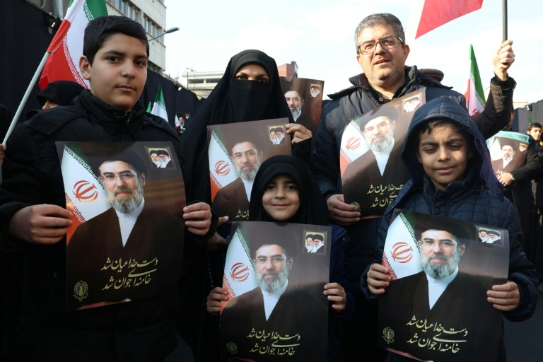 Des manifestants tiennent des portraits du nouveau guide suprême l'ayatollah Mojtaba Khamenei à Téhéran, le 9 mars.
