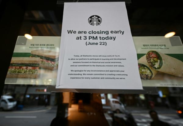 Une affiche annonçant une fermeture anticipée sur la porte d'un café Starbucks à Séoul, en Corée du Sud, le 22 juin 2026
