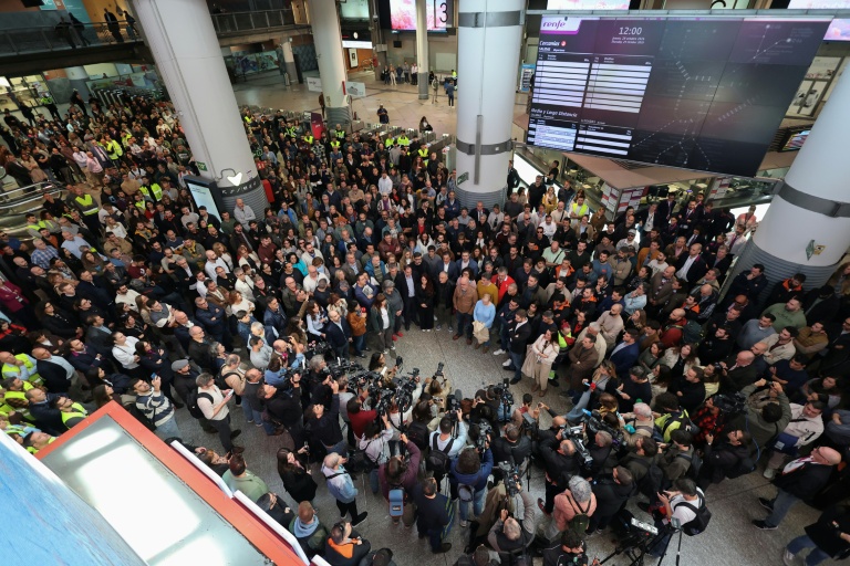 Des voyageurs observent une minute de silence à la gare Atocha à Madrid, en hommage aux victimes de la collision entre deux trains à grande vitesse, le 29 octobre 2026 en Espagne