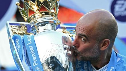 Pep Guardiola embrasse le trophée de la Premier League, le 19 mai 2024 à l'Etihad Stadium
