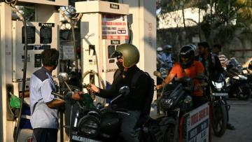 Des motocyclistes font le plein à une station-service à Chennai, le 12 mars 2026 en Inde