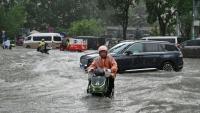 Torrential rain and flooding killed six people and forced at least 130,000 to evacuate in China's Guangxi region