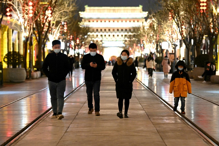 Pedestrians on a street in Beijing, January 31, 2022