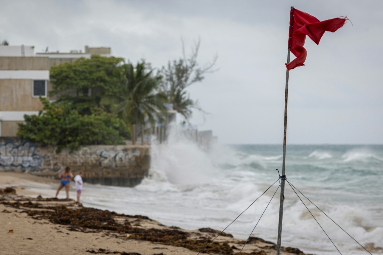 Un drapeau rouge déchiré par les vents violents à l'approche de l'ouragan Erin le 16 août 2025 sur l'île de Porto Rico (Etats-Unis)