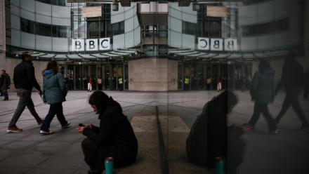 Des passants marchent devant l'entrée des bureaux de la BBC à Londres le 11 novembre 2025