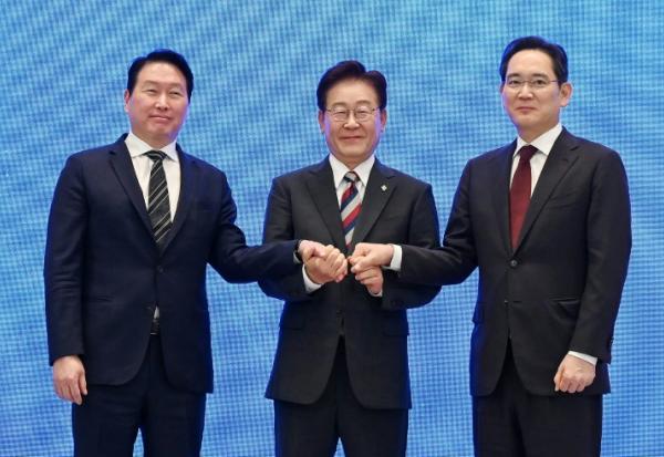 Le président Lee Jae Myung (c) scelle d'une poignée de main un plan public-privé de 1.200 milliards de dollars pour les puces et l'IA, à Séoul, le 29 juin 2026