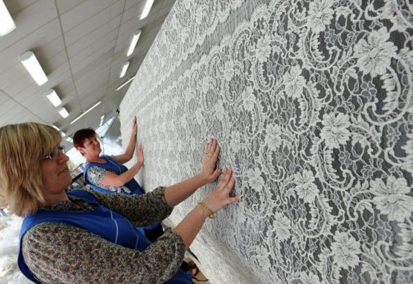 Deux employées de la société Solstiss, à Caudry, travaillent le 3 mai 2011 sur une pièce de dentelle