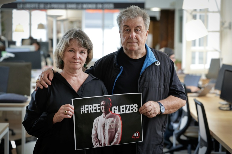 La mère du journaliste Christophe Gleizes, Sylvie Godard, et son beau-père Francis Godard tiennent avec une affiche appelant à sa ibération, le 27 août 2025 à Paris