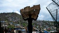 Un homme transporte des matériaux pour reconstruire sa maison à Mamoudzou, à Mayotte, le 2 janvier 2025