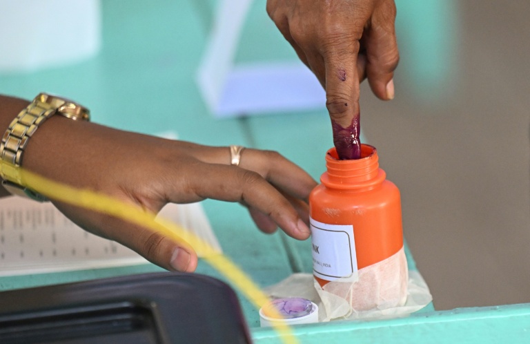 Un homme trempe son index dans de l'encre après avoir voté lors de l'élection présidentielle au Guyana, à Georgetown, le 1er septembre 2025