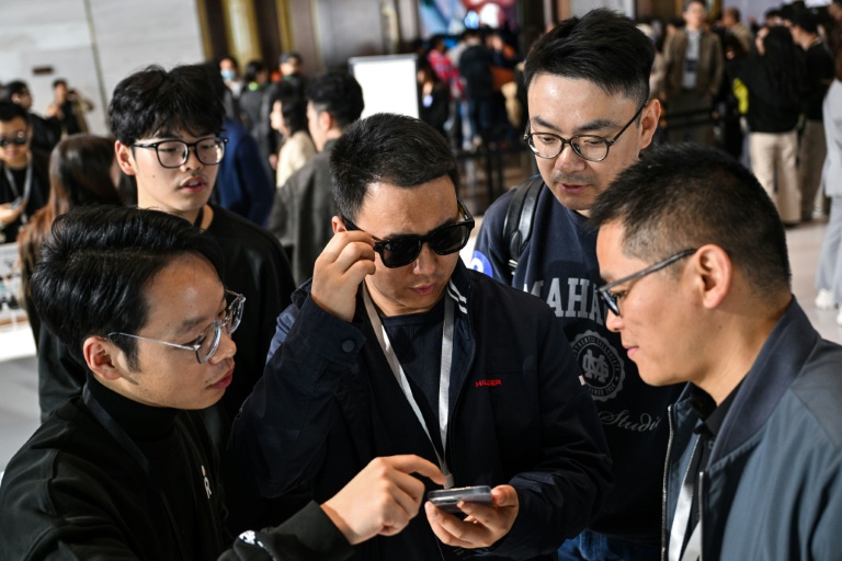 Cette photo, prise le 13 novembre 2025, montre un homme testant le nouveau modèle de lunettes de Rokid Bolon grâce à l'intelligence artificielle (IA) lors d'une présentation à Hangzhou, dans la province du Zhejiang, en Chine orientale