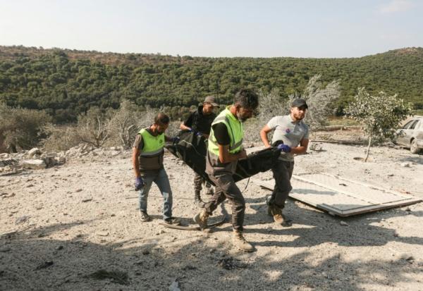Les premiers secours évacuent un corps des décombres à la suite d'une frappe aérienne israélienne qui a visé une maison dans le village d'Ansar, dans le sud du Liban, le 15 août 2026. 