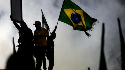 Un partisan du sénateur brésilien de droite et candidat à la présidence, Flavio Bolsonaro, agite un drapeau national lors d'un meeting de campagne à  Rio de Janeiro, le 3 octobre 2026