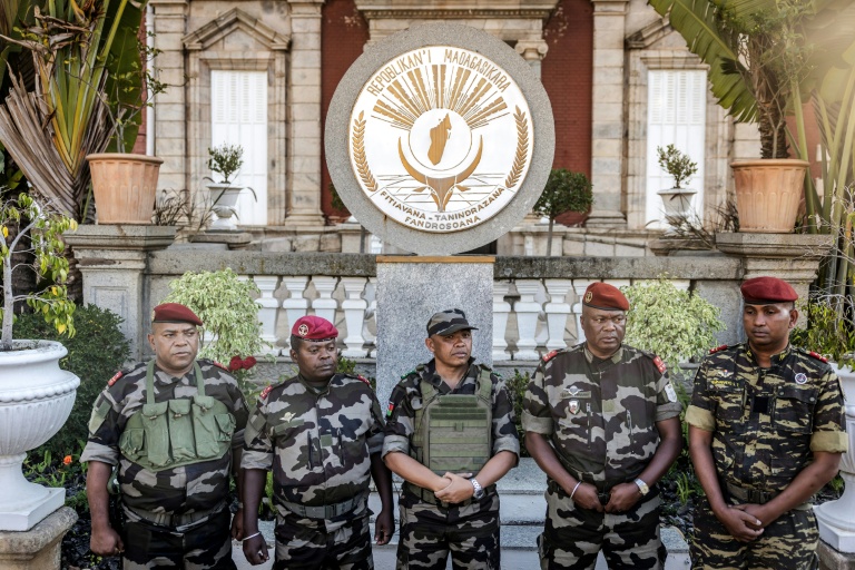 Colonel Michael Randrianirina (C) has pledged to lead the impoverished Indian Ocean island to civilian leadership in under two years