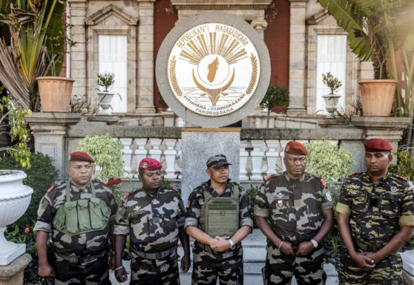 Colonel Michael Randrianirina (C) has pledged to lead the impoverished Indian Ocean island to civilian leadership in under two years