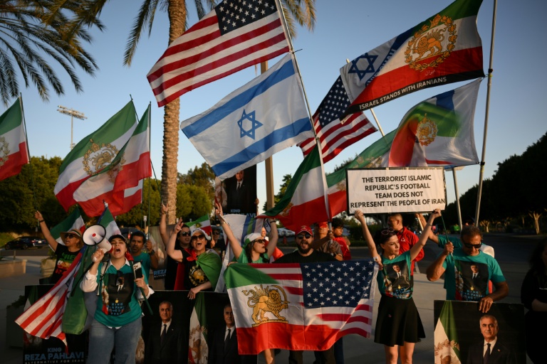 Des manifestants agitent des drapeaux de l'Iran pré-révolutionnaire à l'extérieur du stade où s'entraîne la sélection iranienne, le 14 juin 2026 à Los Angeles, à la veille de son entrée en lice dans le Mondial contre la Nouvelle-Zélande