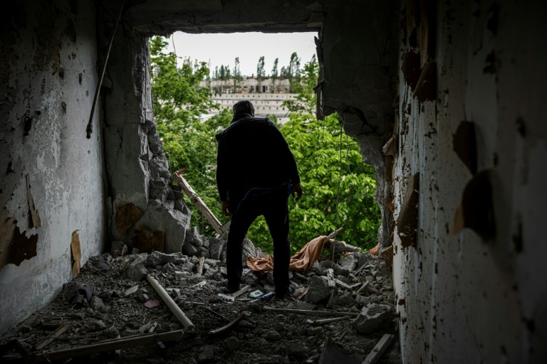 A man in the rubble of an apartment in the Saltiveka district, north of Kharkiv, Ukraine, May 15, 2022.