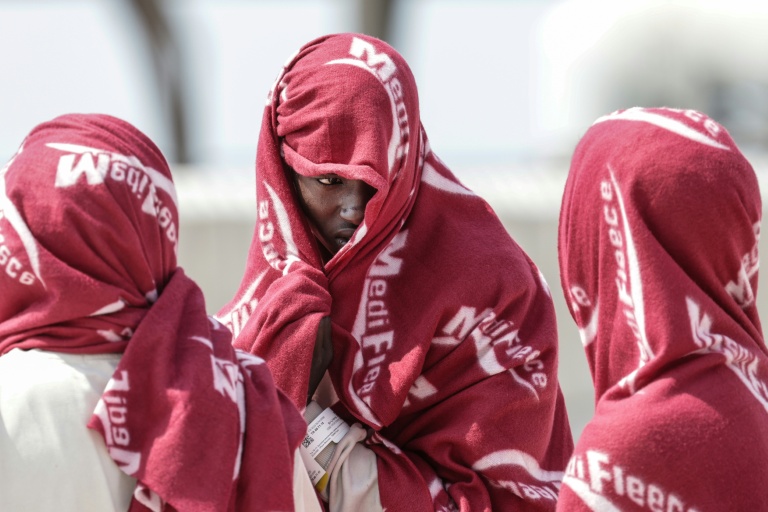 Des migrants attendent après avoir débarqué d'un navire après leur sauvetage en mer alors que leur embarcation avait pris feu lors d'une tentative de traversée de la Manche, au port de commerce de Boulogne-sur-Mer, le 4 août 2026