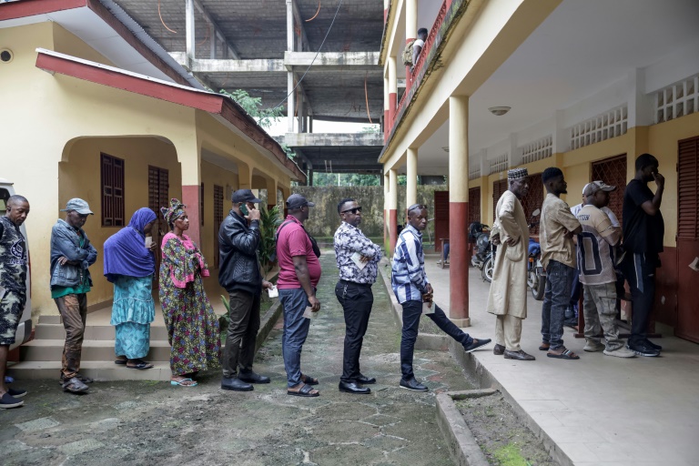 Les électeurs font la queue devant un bureau de vote dans une école de Conakry, le 21 septembre 2025, alors que la Guinée vote lors d'un référendum constitutionnel.