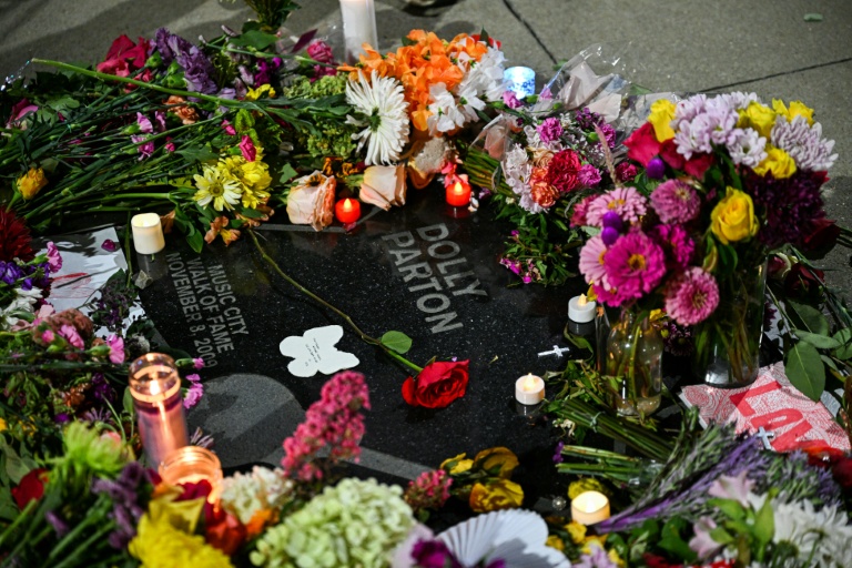 Flowers and candles cover Dolly Parton's star on The Music City Walk of Fame in Nashville, Tennessee