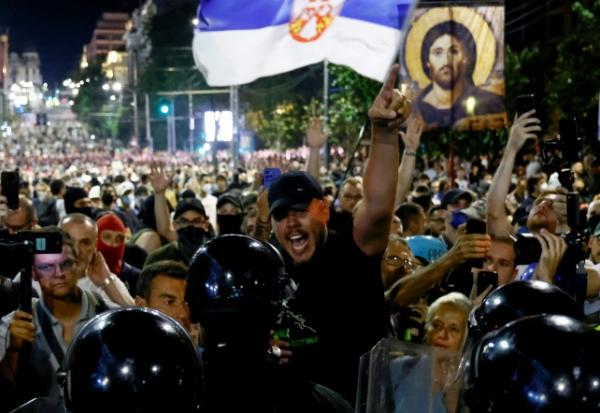 Des policiers anti-émeutes face à des manifestants hostiles au gouvernement à Belgrade le 15 août 2025 