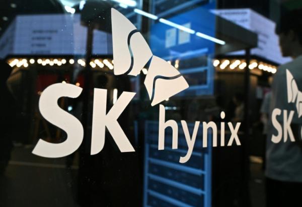 Le logo de SK hynix est projeté sur une paroi en verre lors du Salon mondial des technologies de l'information 2026, à Séoul, le 22 avril 2026