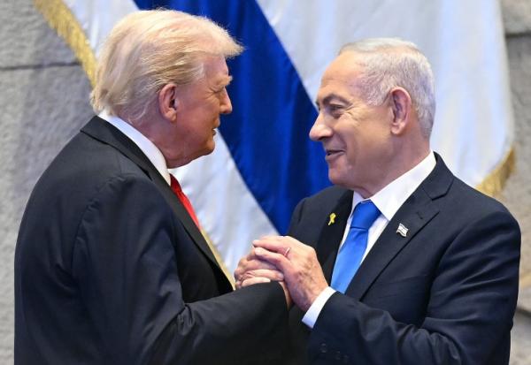 Le président américain Donald Trump (g.) échange avec le Premier ministre israélien Benjamin Netanyahu, le 13 octobre 2025 à Jérusalem