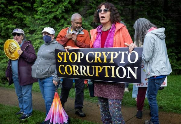 Des manifestants devant le Trump National Golf Course à Sterling, en Virginie, le 22 mai 2025, où le président Donald Trump participe à un dîner privé dans son club pour les 220 plus gros détenteurs de sa cryptomonnaie