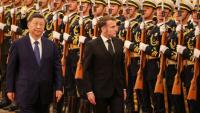 Le président chinois Xi Jinping (à gauche) et le président français Emmanuel Macron (à droite) passent en revue la garde d'honneur lors d'une cérémonie de bienvenue au Palais du Peuple à Pékin, le 4 décembre 2025