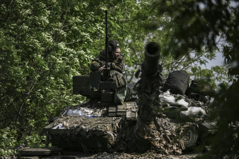 Ukrainian soldiers will board a tank on May 20, 2022, not far from the front line near Lysychans'k in eastern Ukraine.