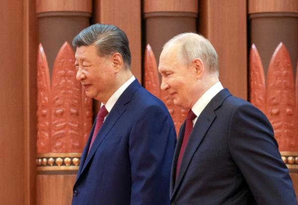 hoto diffusée par l'agence de presse russe Sputnik montrant le président russe Vladimir Poutine (d) et le président chinois Xi Jinping lors de leur rencontre à Pékin, le 20 mai 2026